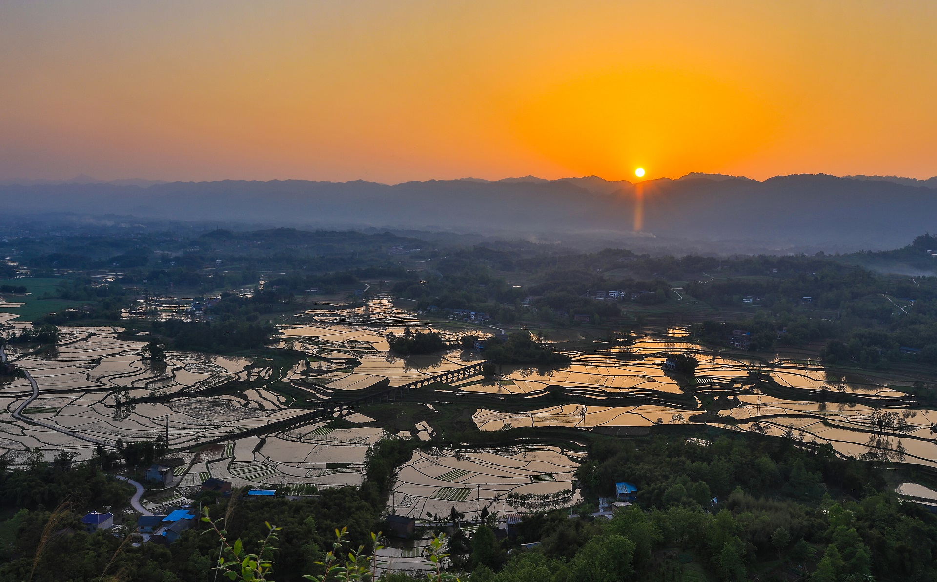 红岩坝春光美——仲春时节，落日余晖下，明达镇红八村红岩坝，柔和的晚霞映照着蓄满春水的稻田，犹如一幅美丽的田园画卷。记者 熊伟 摄.jpg